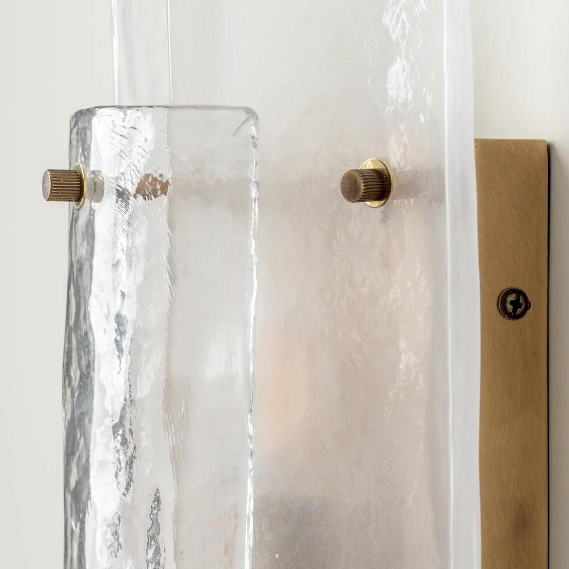 Close view of the textured glass wall light against a clean wall
