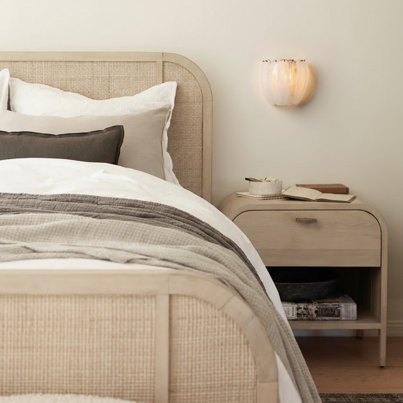 Velora wall lamp beside a bed