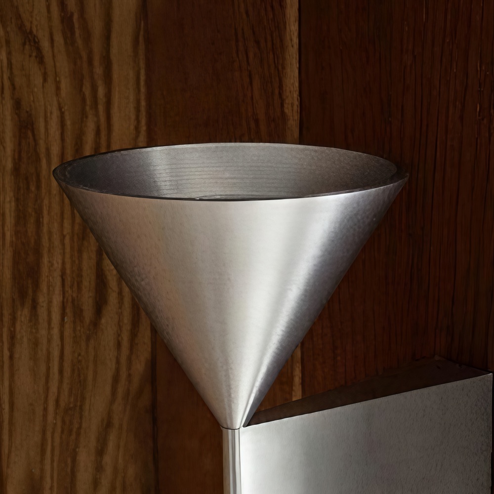 Brushed metal cone detail on the Metorq wall lamp