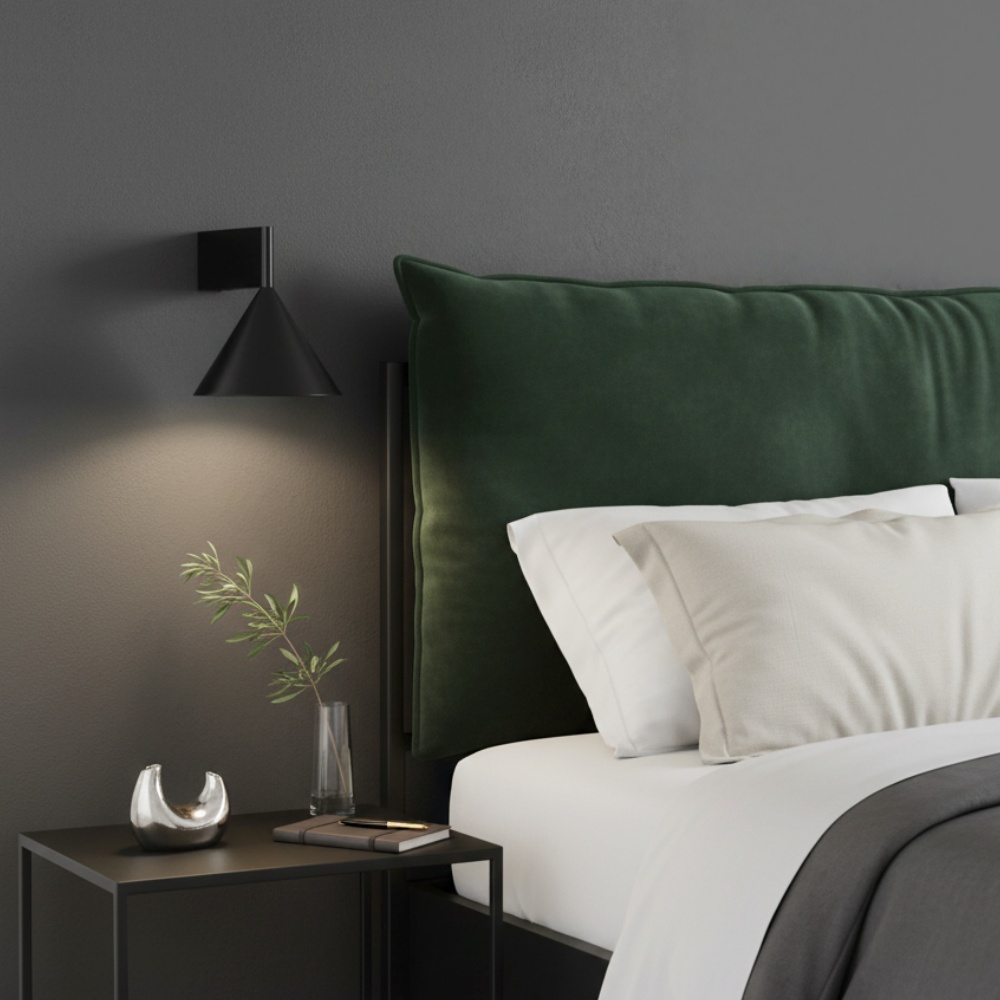 Black Metorq wall lamp beside a bed