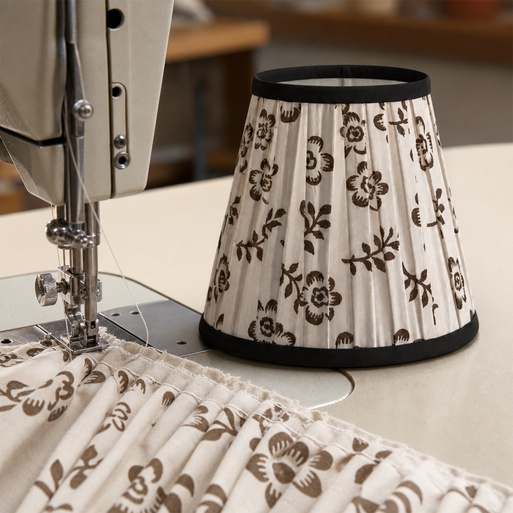 Pleated floral lampshade being made beside a sewing machine
