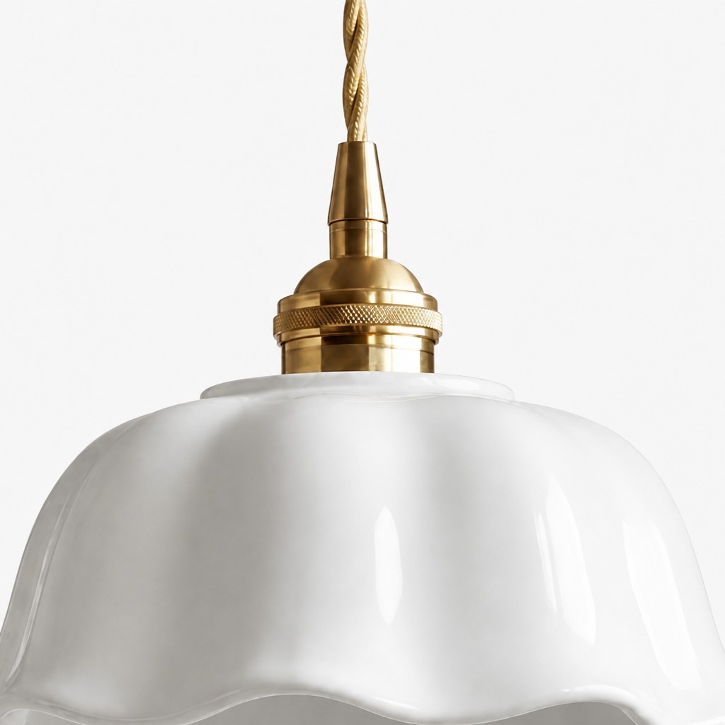Close-up of the brass pendant stem and white ceramic flower shade