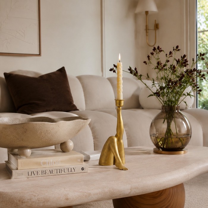 A modern American living room featuring an asymmetrical coffee table and curved decorative objects