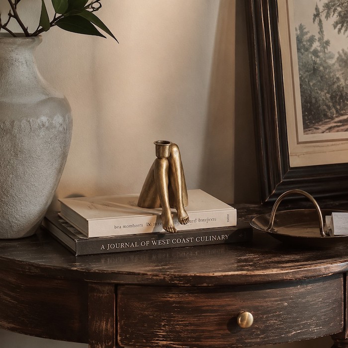 Contemporary sculptural decor sitting elegantly on a vintage side table.