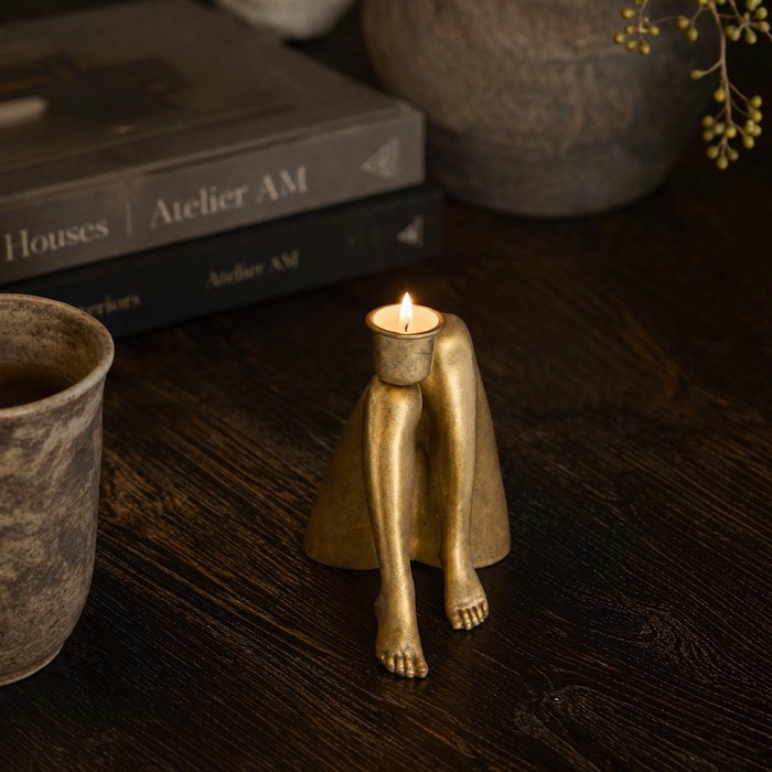 Close-up of a Quirky Legs candle holder as a centerpiece.