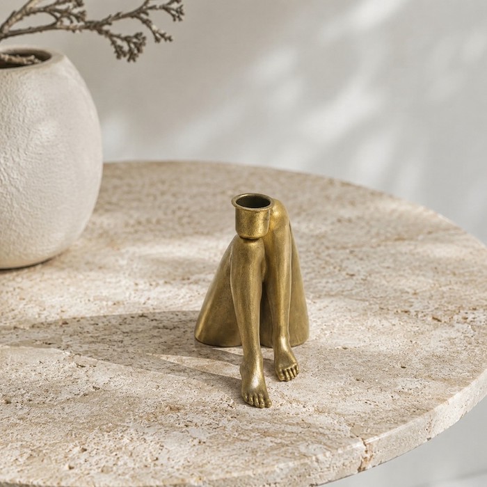 Detailed view of a matte-finish sculptural candle holder.