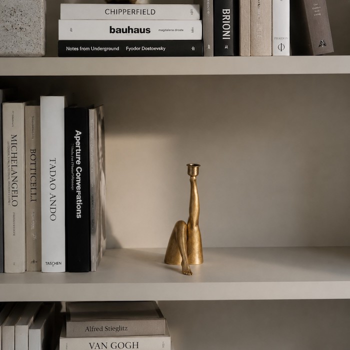 Stylized bookshelf with artistic human-silhouette decor.