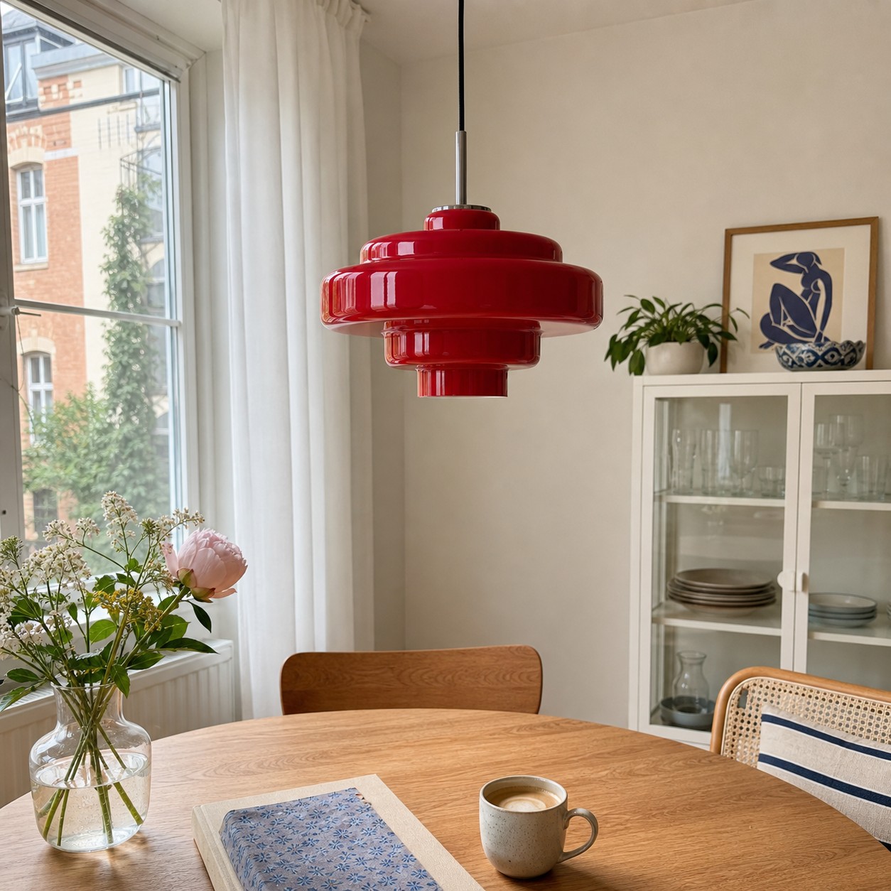 Elegant glass pendant light casting a warm glow over an oak breakfast table
