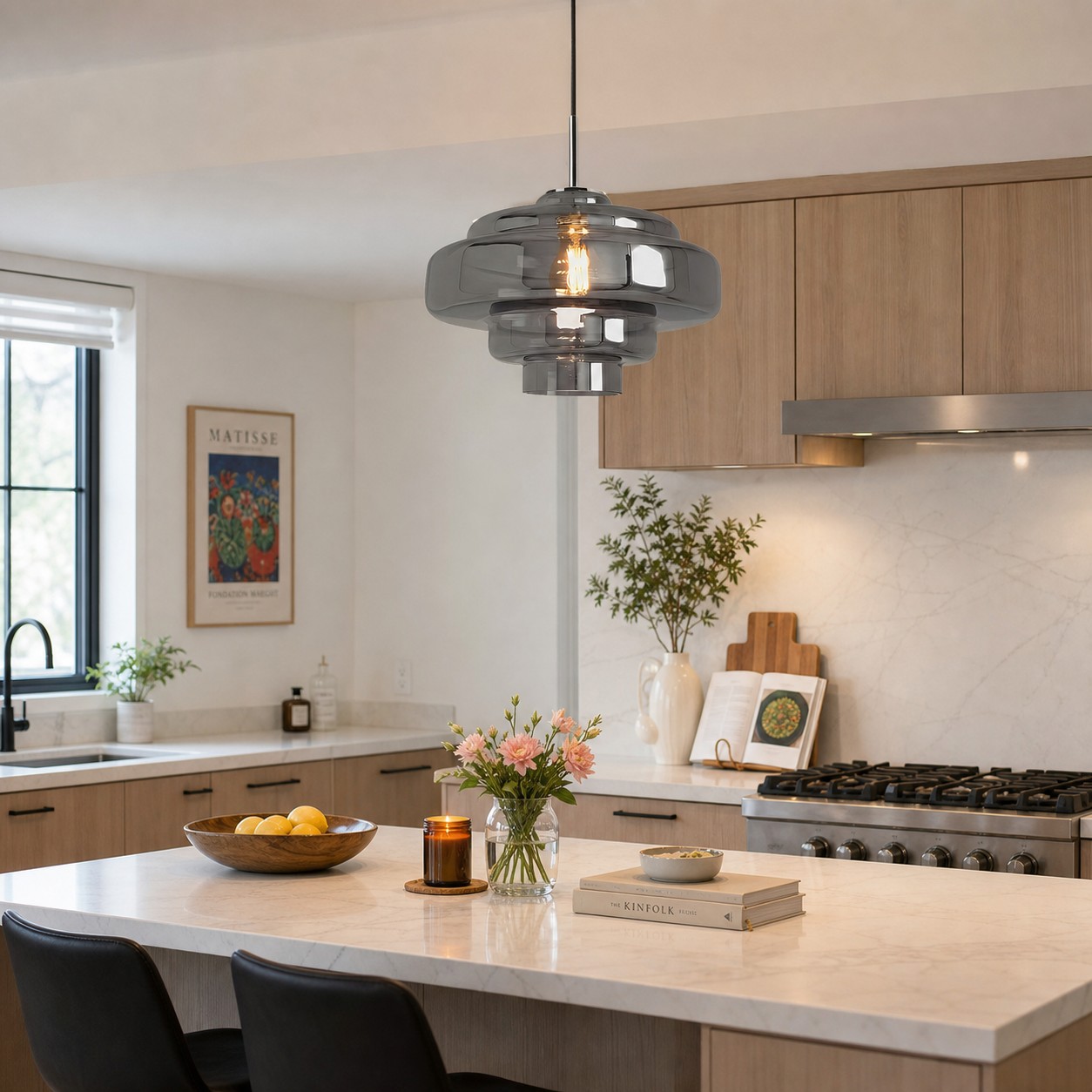 A smoke-grey glass pendant positioned above a modern kitchen island.
