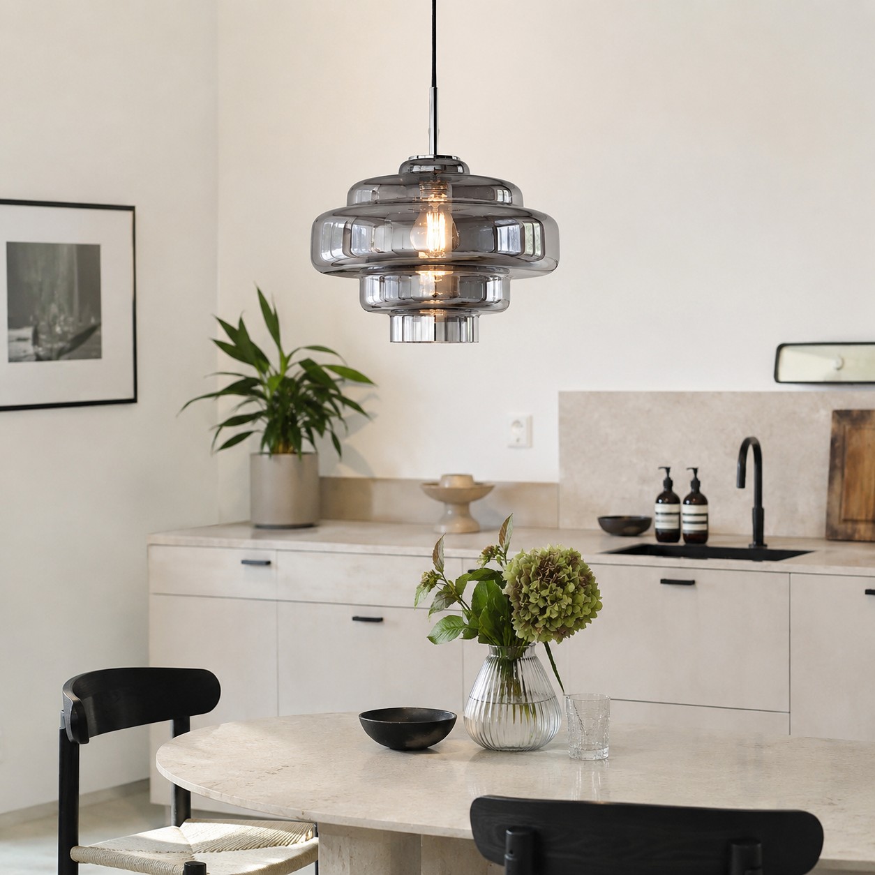 Smoke grey Koloro Millie pendant outlined against pale mineral finishes.