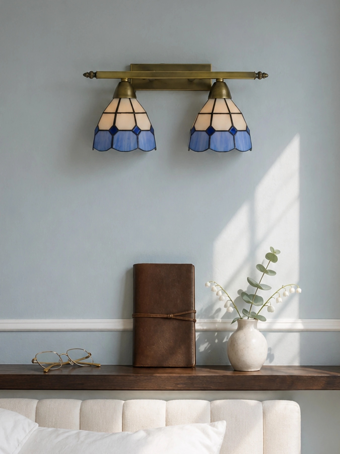 Tiffany-style stained glass lamp illuminating a room scene