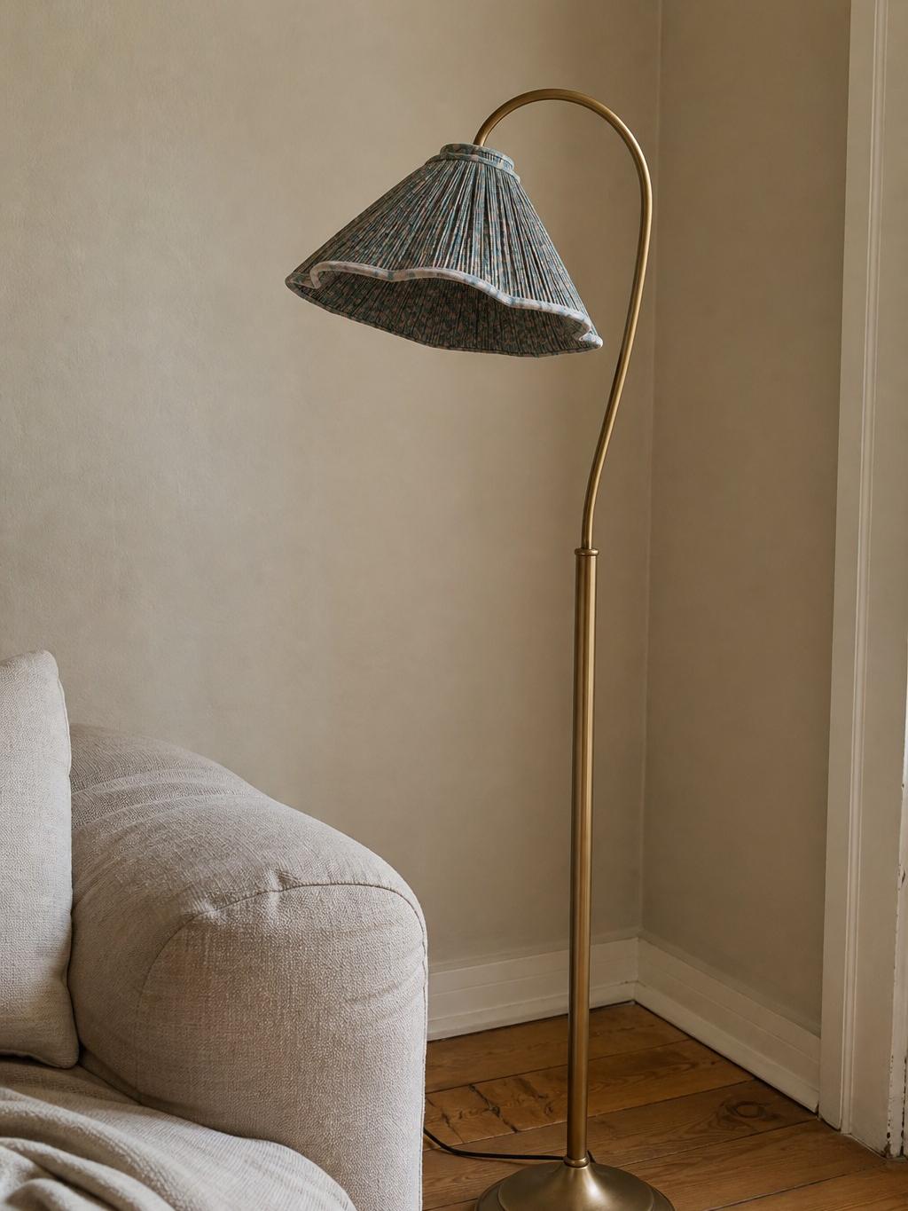 Vintage floral floor lamp beside an armchair
