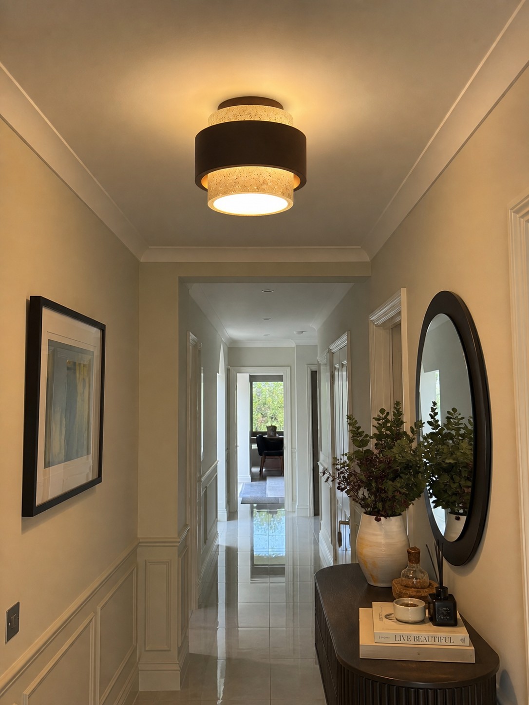 A compact brown ceiling light illuminating a hallway