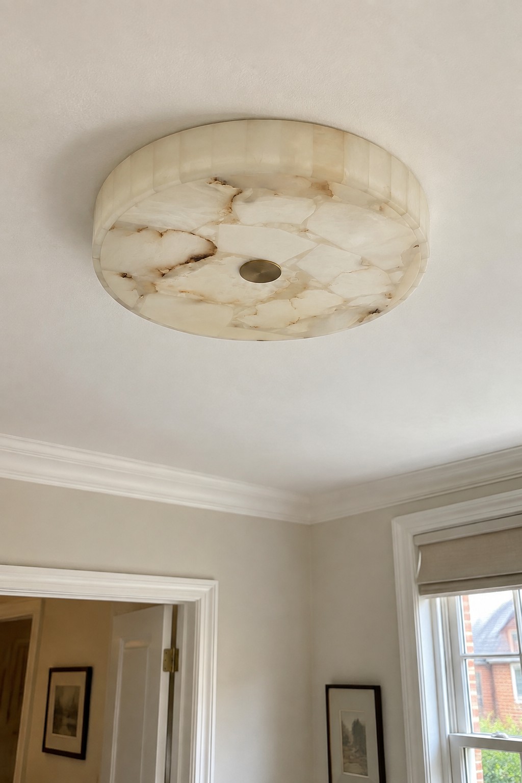 A pale veined stone ceiling light in a living space