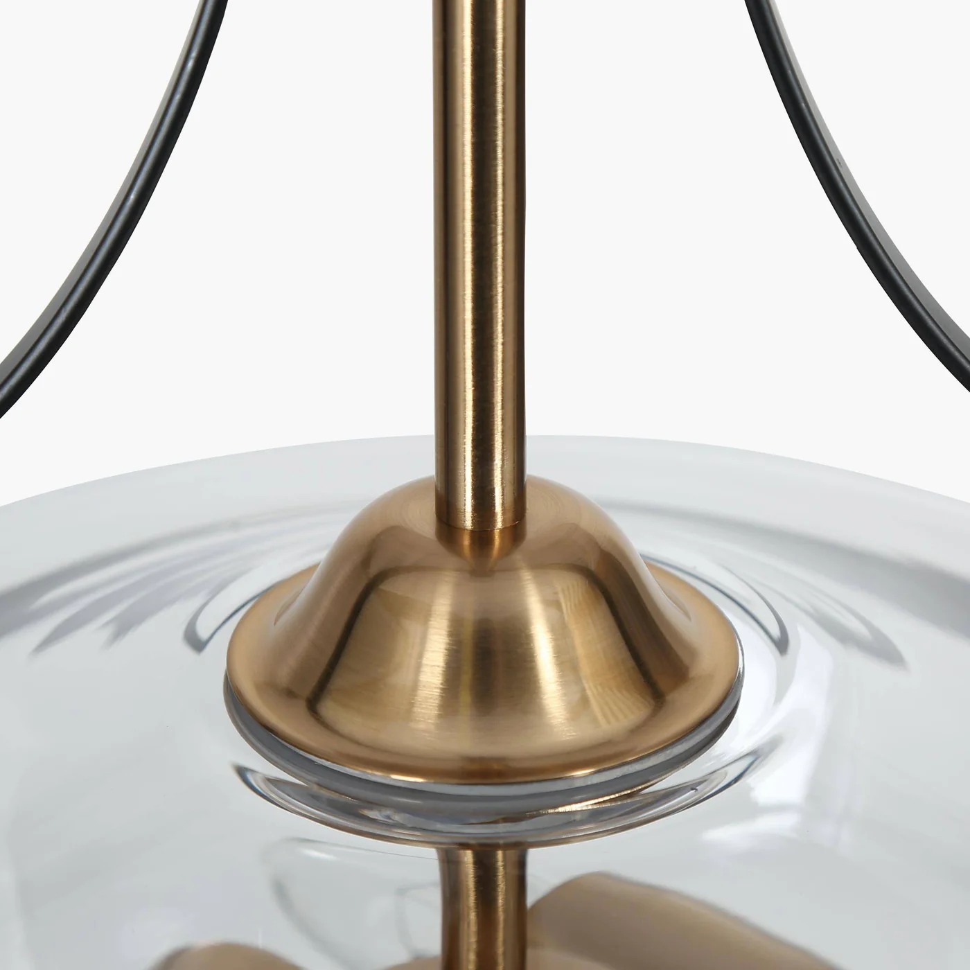 Close-up of clear glass bowl and brass detail