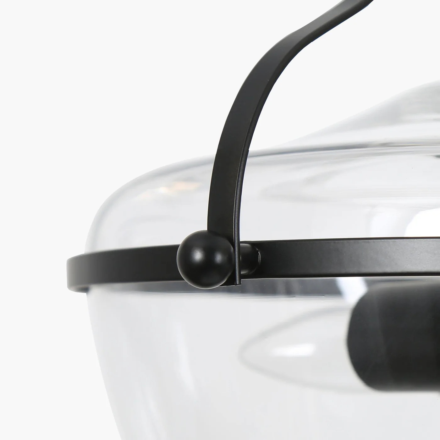 Close-up of black metal frame and glass shade