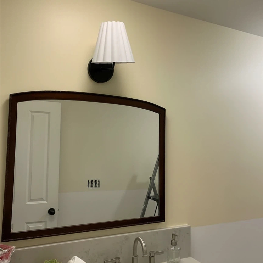 Customer room with Ruffmeto wall sconce above a mirror