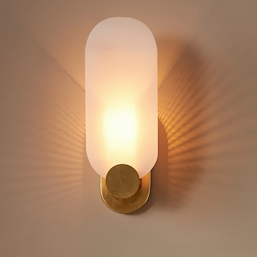 Albi wall sconce illuminated with warm diffused glow