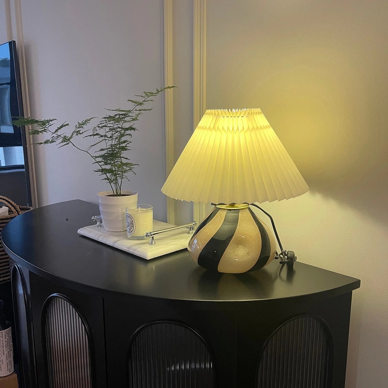 Customer photo of Undara table lamp glowing on a dark table