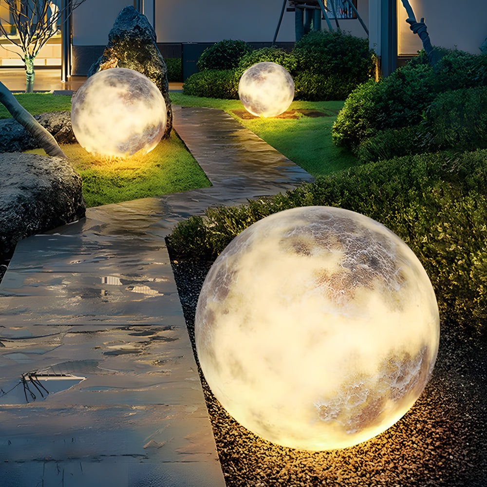 Moon lamps lighting a garden walkway