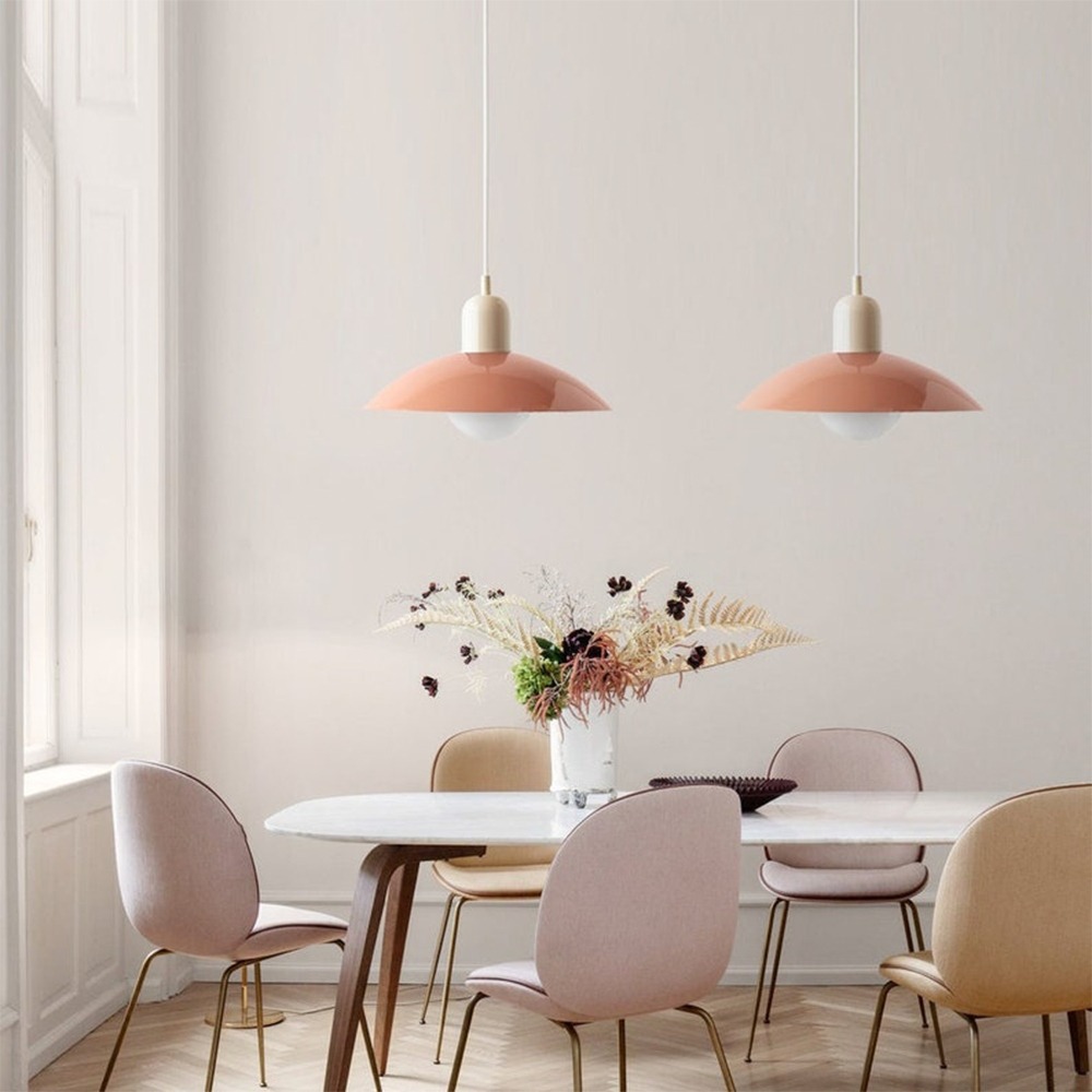 Pink Macaron pendant lights above a dining table