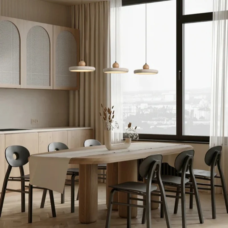 Travertine pendant lights above a dining area