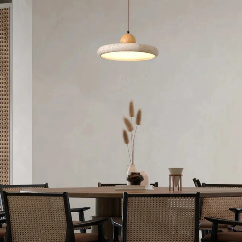 Travertine pendant light above a dining table
