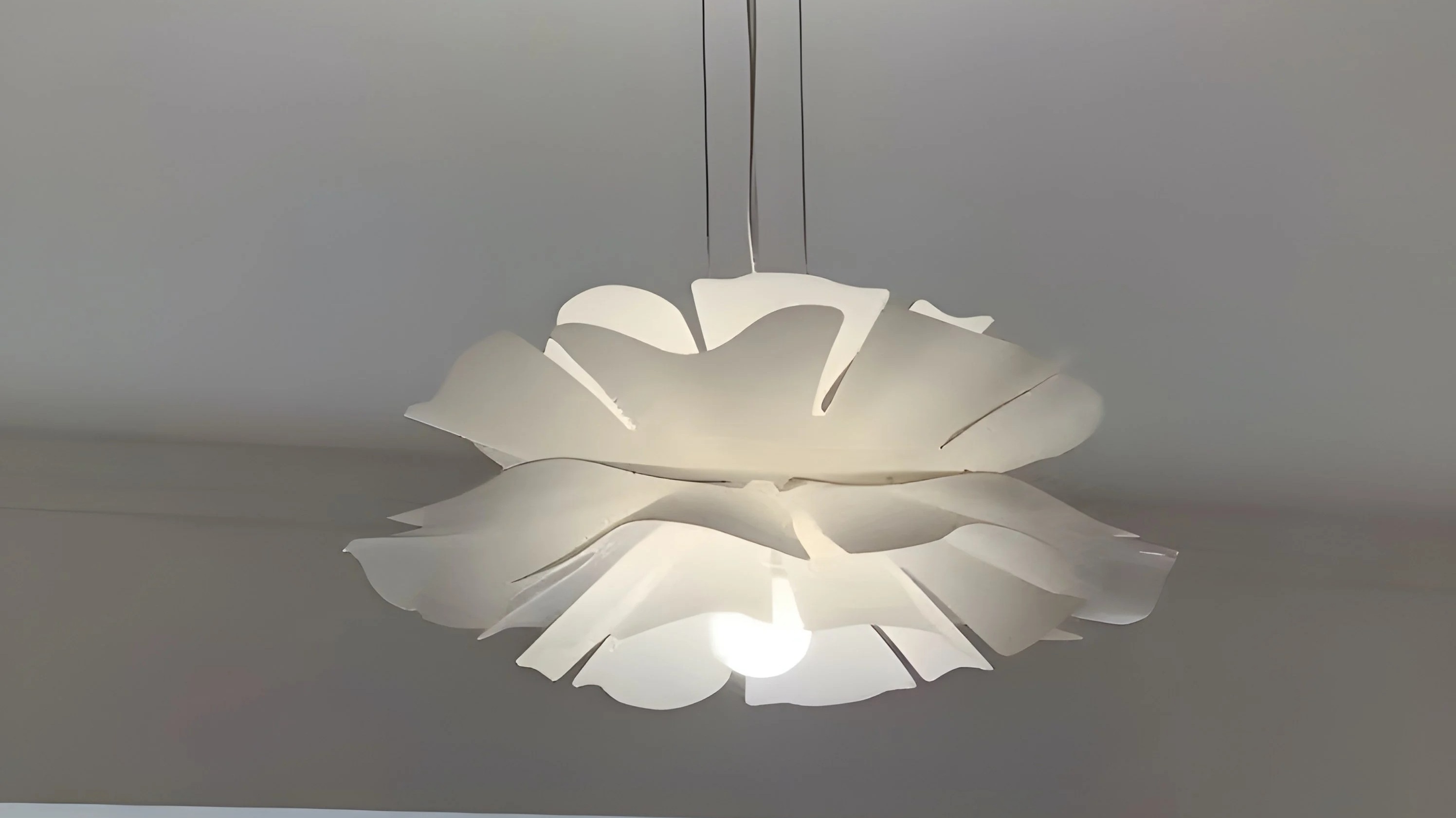 White lotus flower pendant glowing close-up