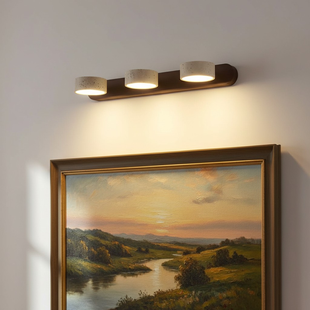 Travertine wall light above framed painting