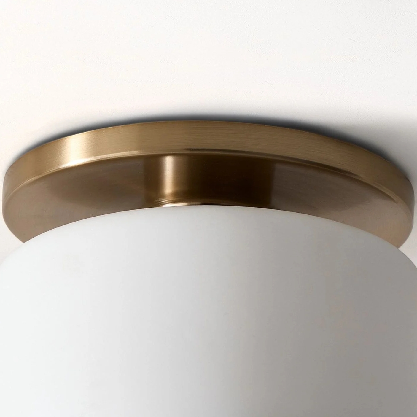 White porcelain shade and brass ceiling base detail