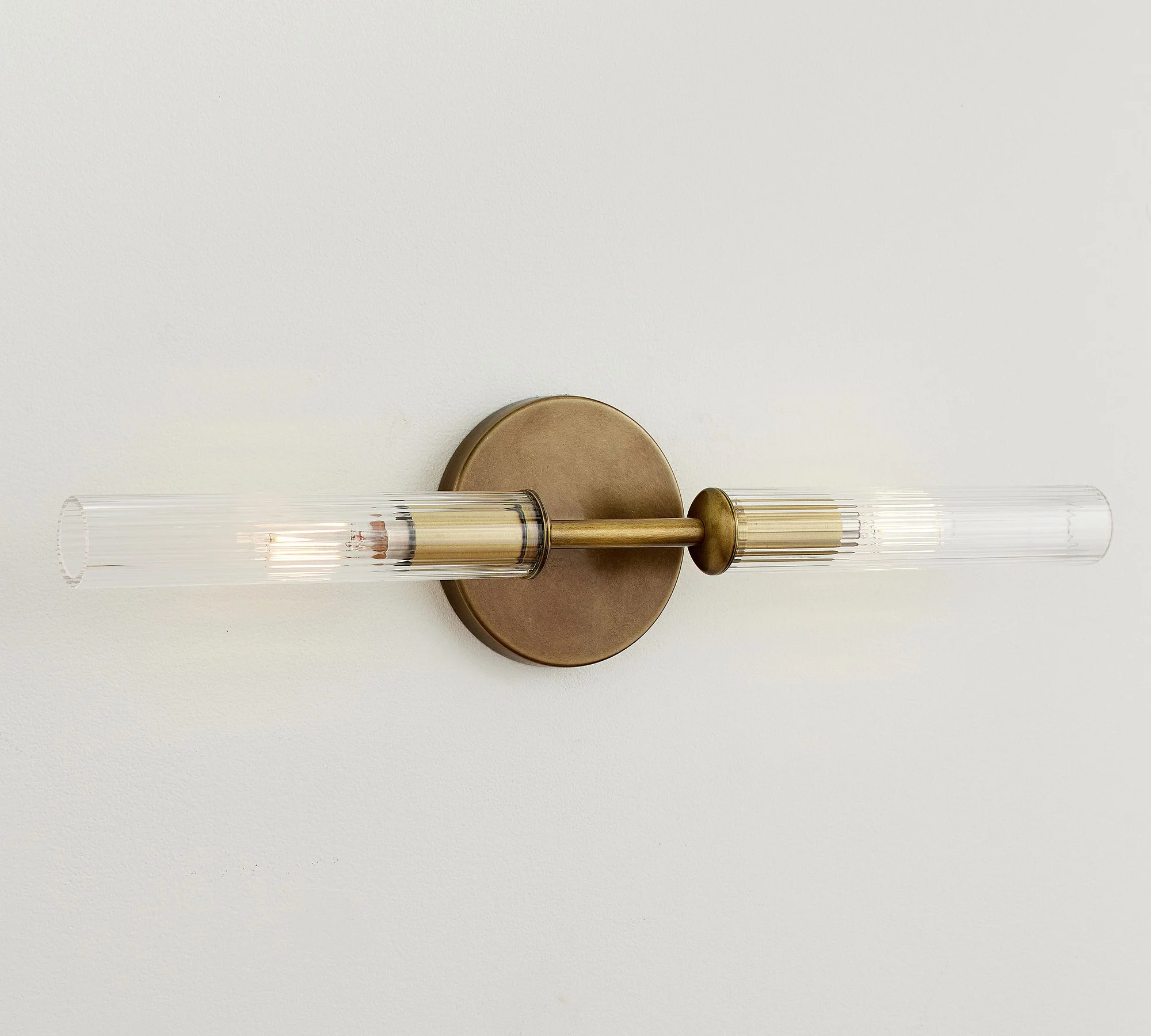 Tumbled brass double tube wall light finish
