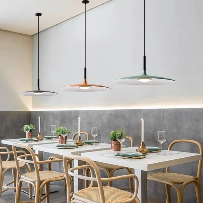 Multiple Large Disc Industrial Pendant Lights over a dining table
