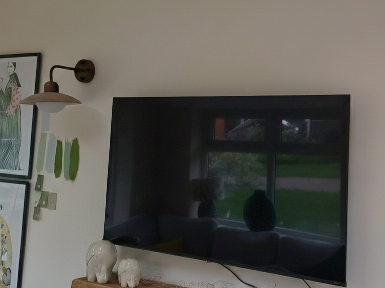 Customer photo of Travertine Wall Lamp near a television