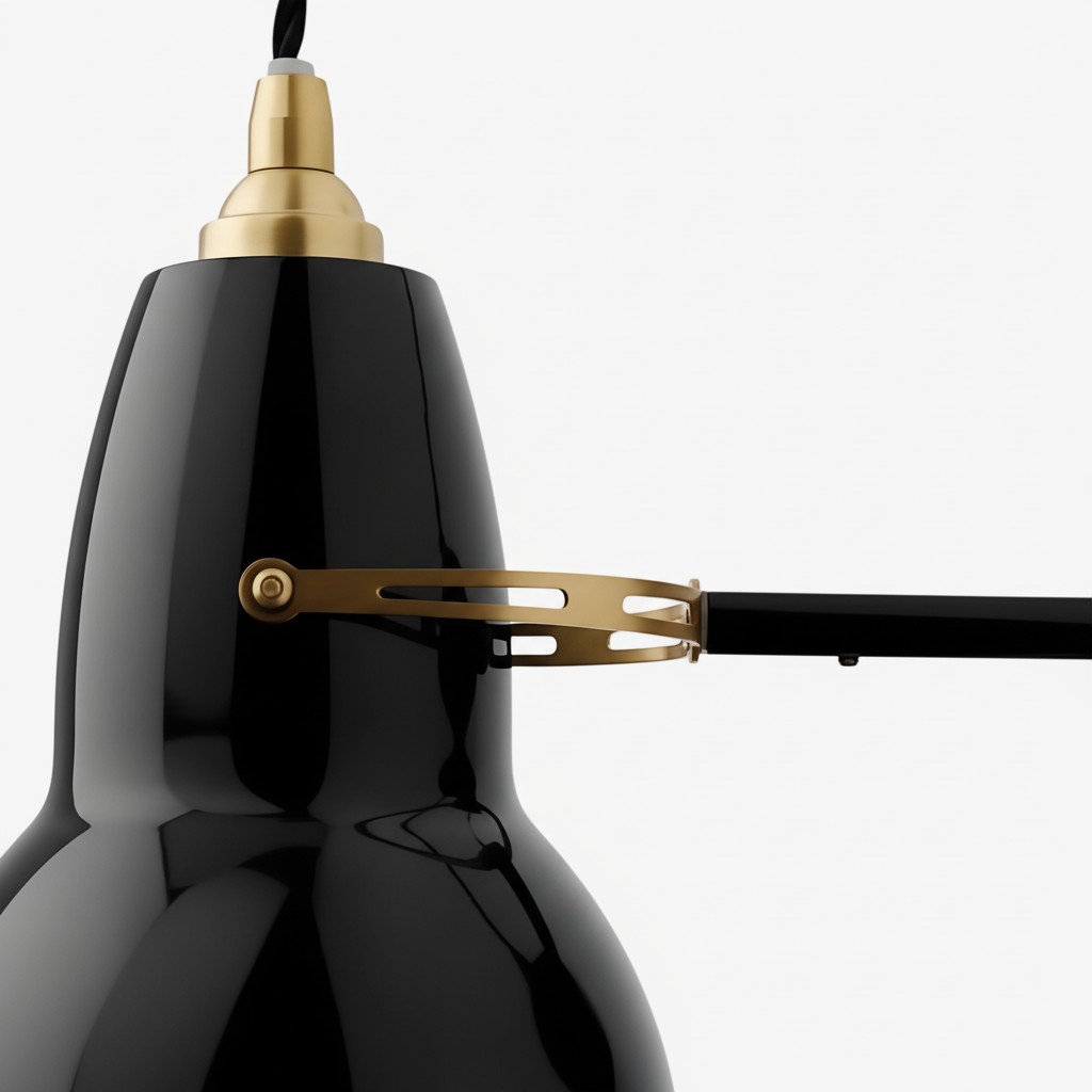 Black wall light shade with brass adjustment detail