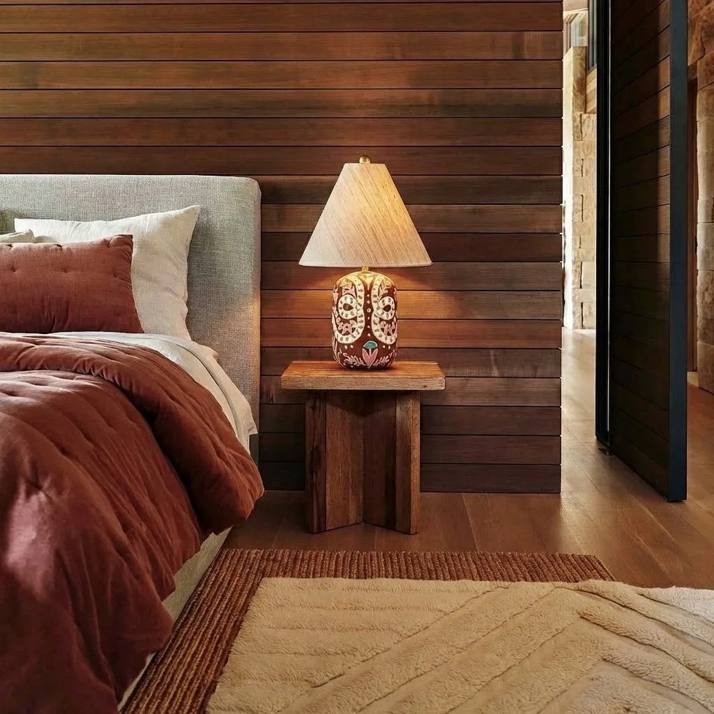 Ceruna table lamp glowing beside a bed