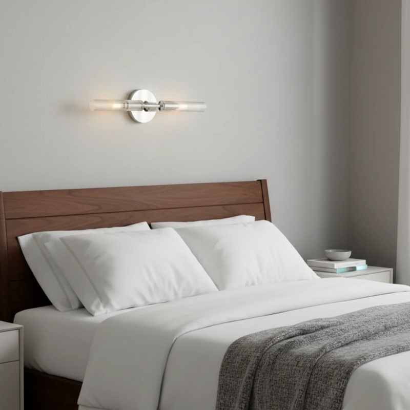 Bravira double tube wall light above a bed
