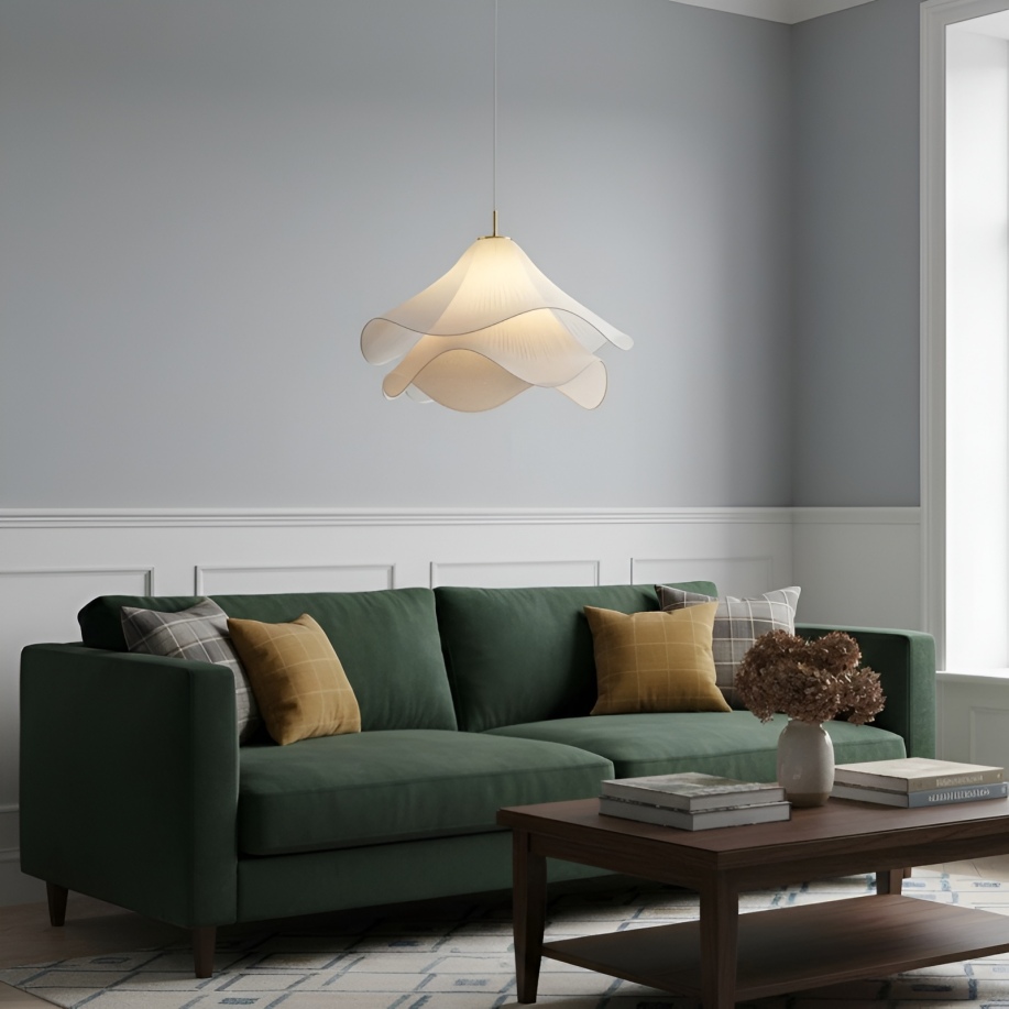 Pendant light above a green sofa