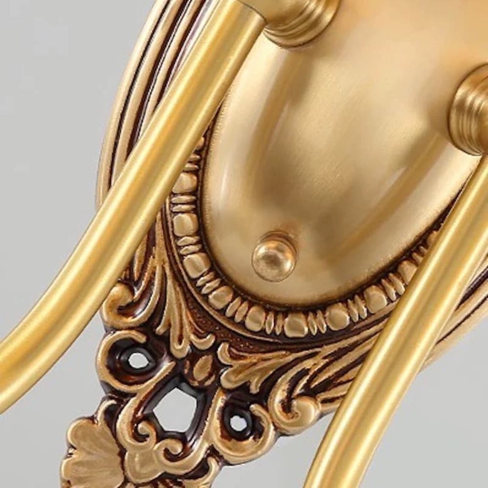 Close-up of ornate gold wall light base detail