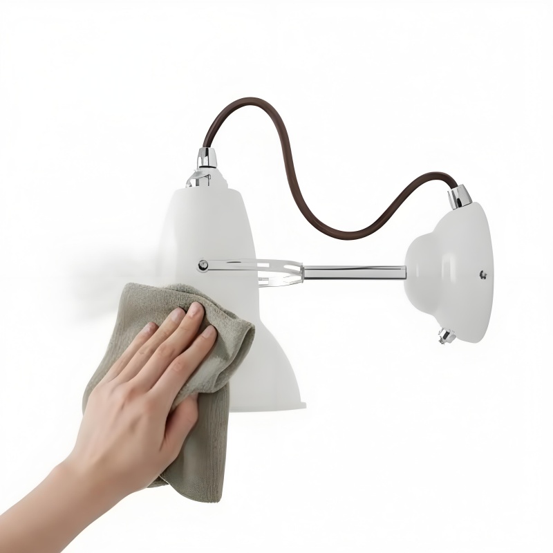 Cleaning the wall light with a dry cloth