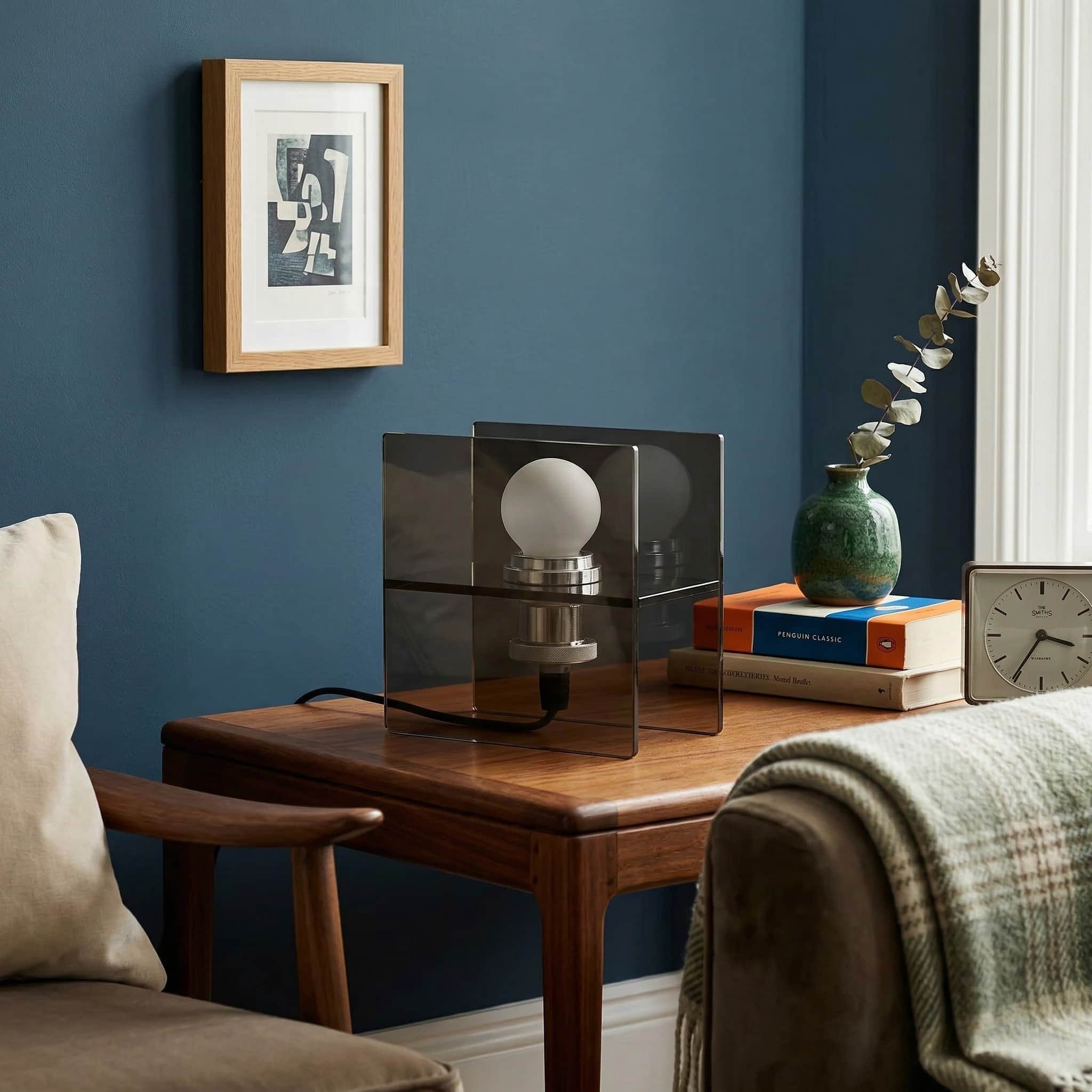 Lamp displayed on a side table with blue wall decor