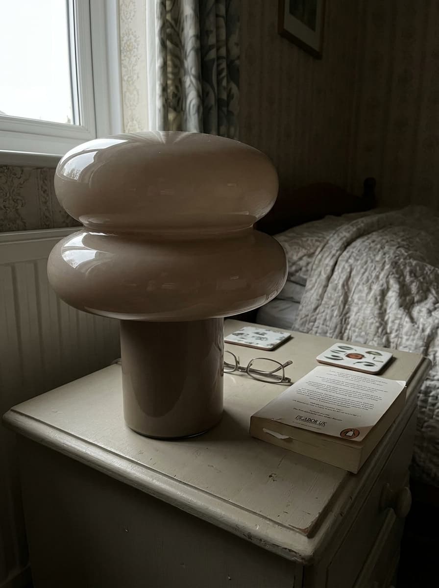 Grey Orra lamp by a bedside