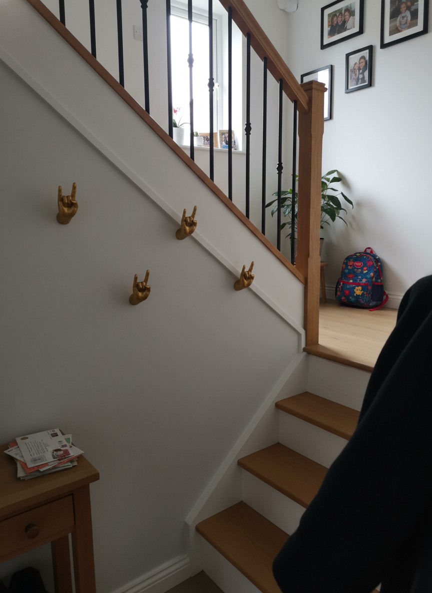 Customer photo of gold hand hooks by a staircase
