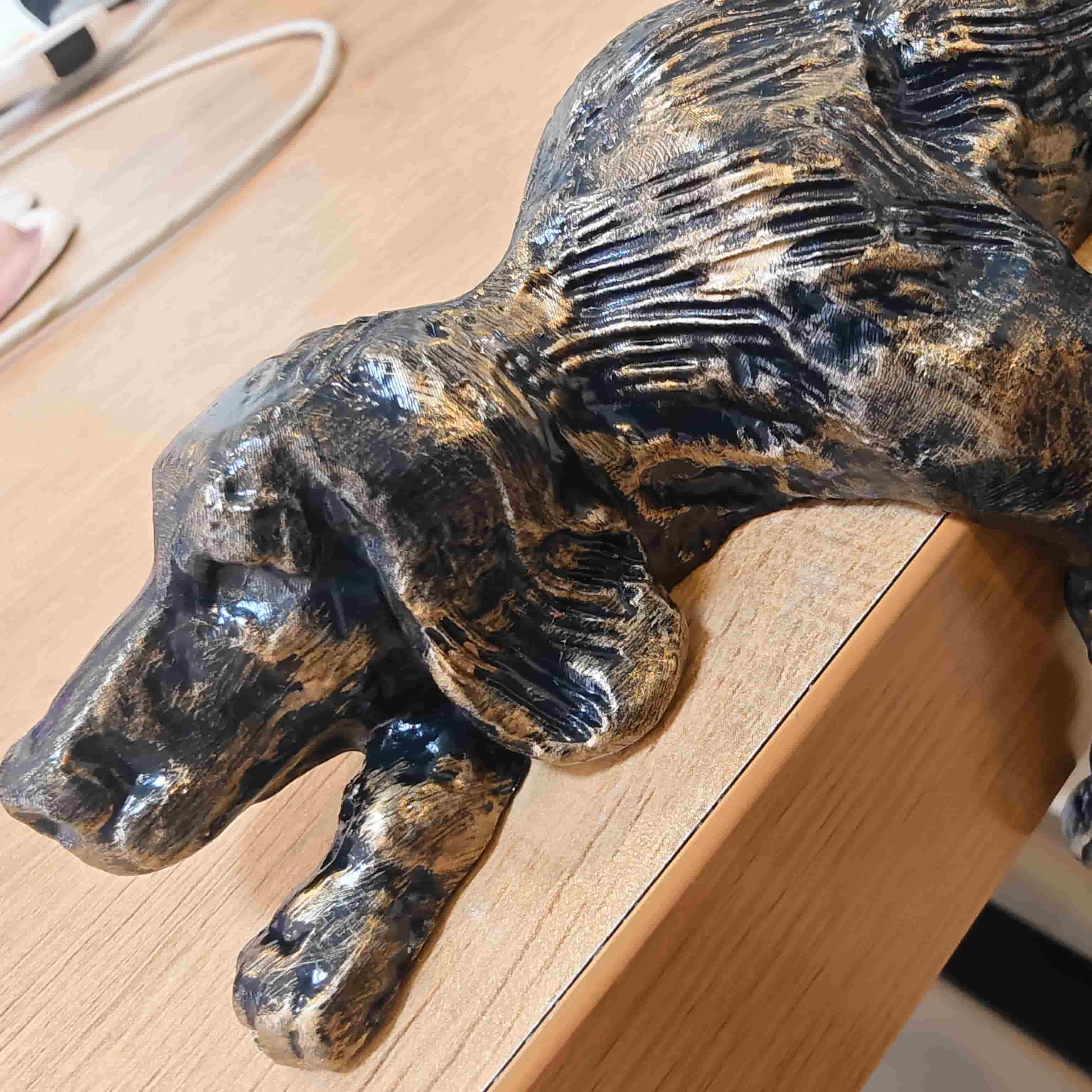 Close-up of the Floxo Lazy Dog Sculpture head and bronze texture