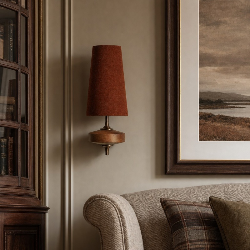 Red Luvora wall light beside armchair