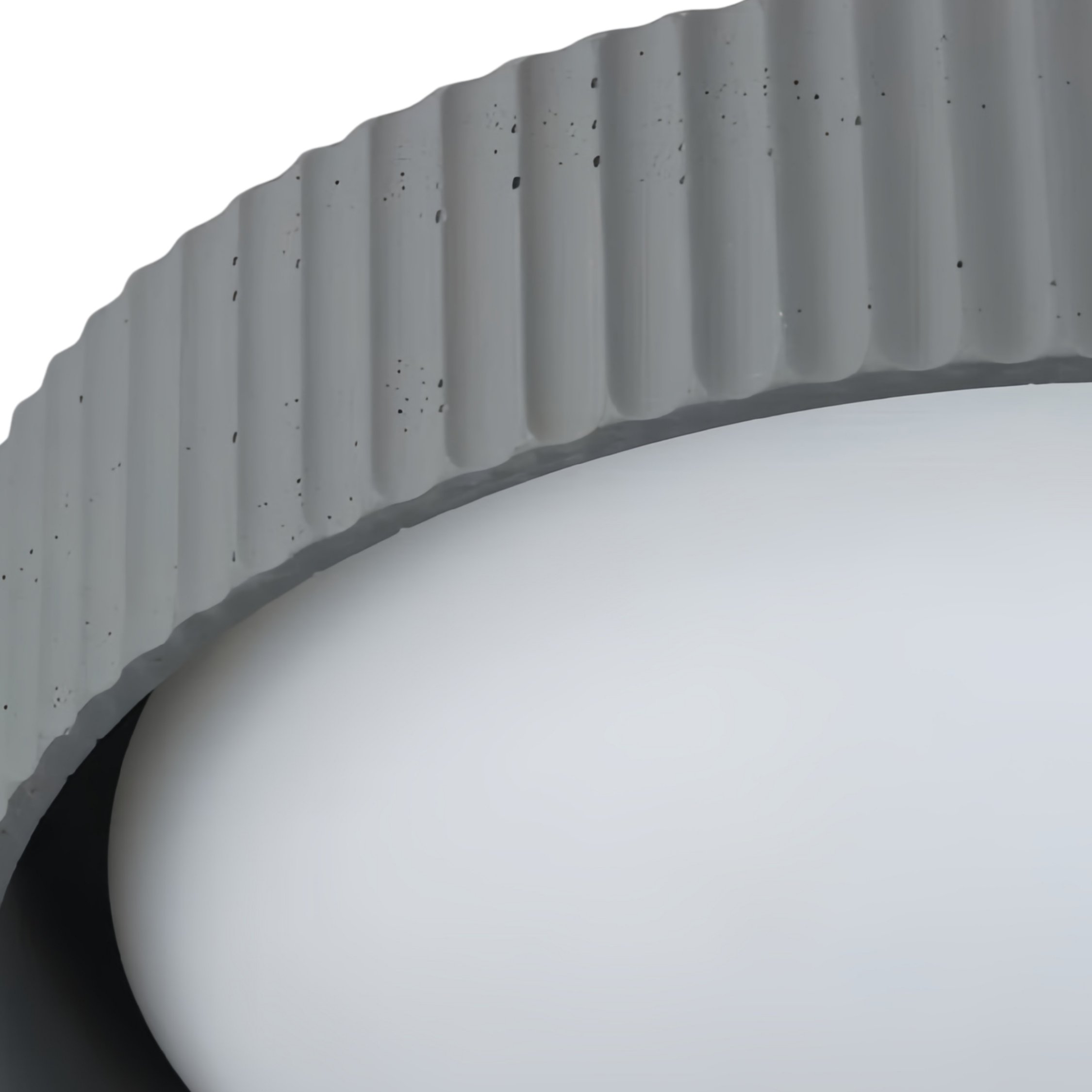Close-up of the Acrion gray fluted concrete-style rim and acrylic diffuser