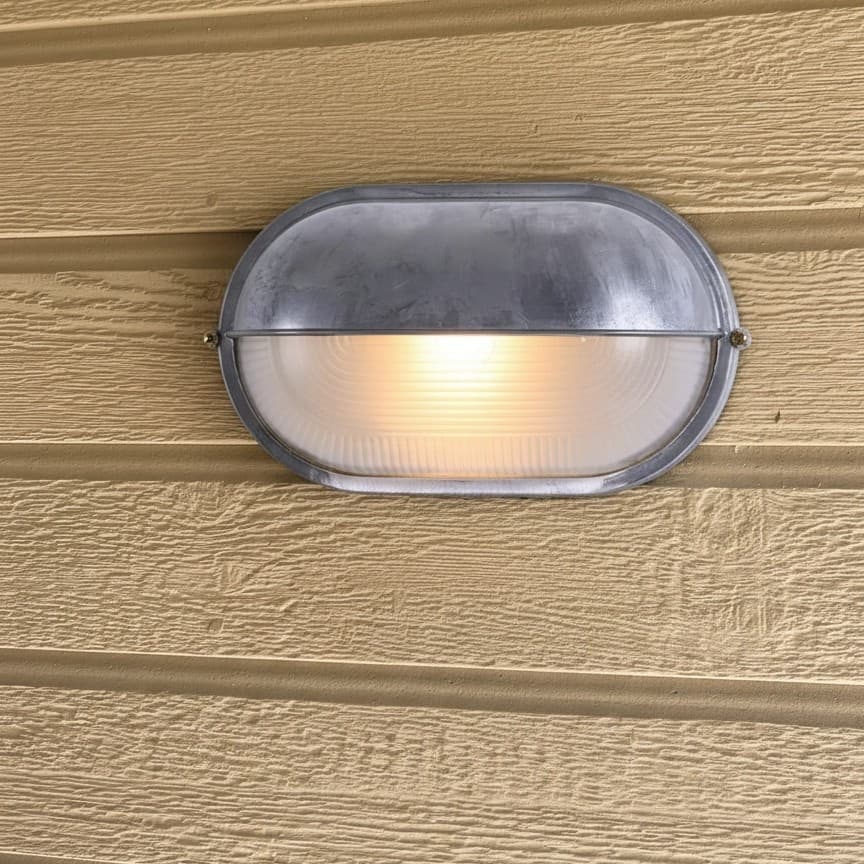Customer installation of Docka wall sconce on siding