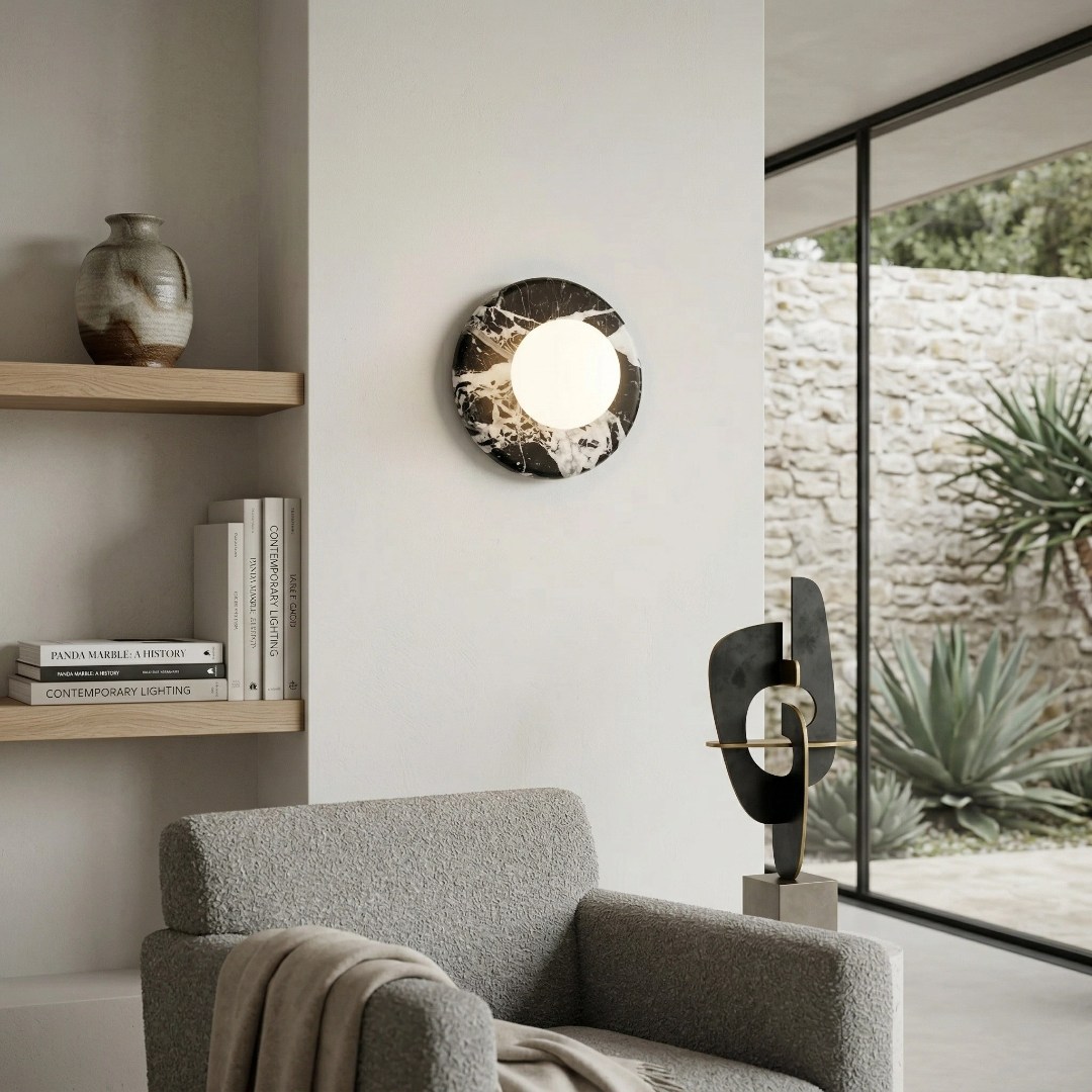 Oria wall lamp beside shelves and a lounge chair
