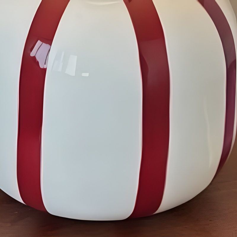 Close view of the red and white ceramic lamp base