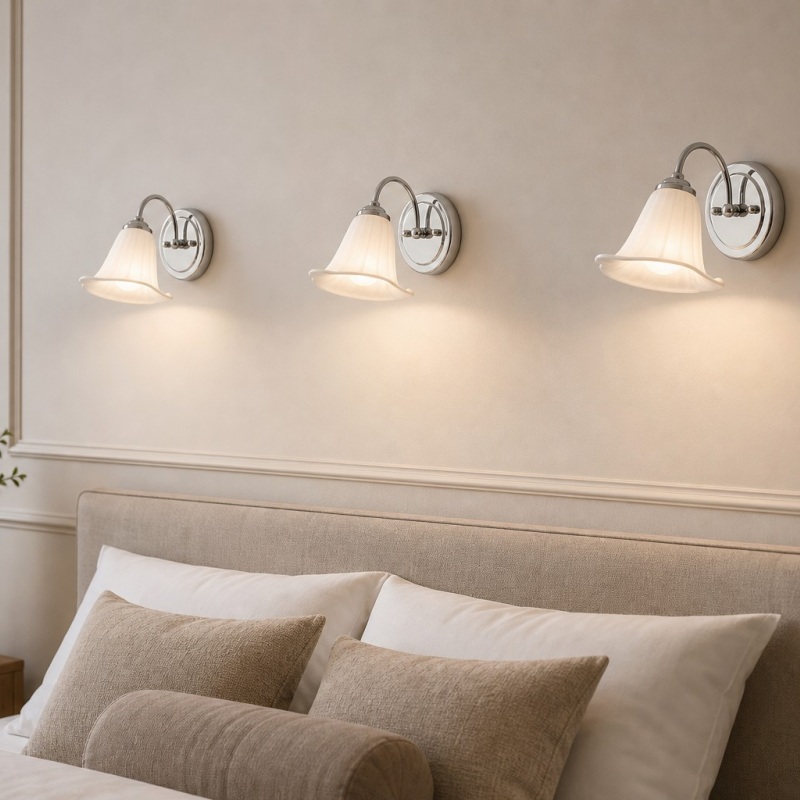 Three calla lily wall lamps above a bed