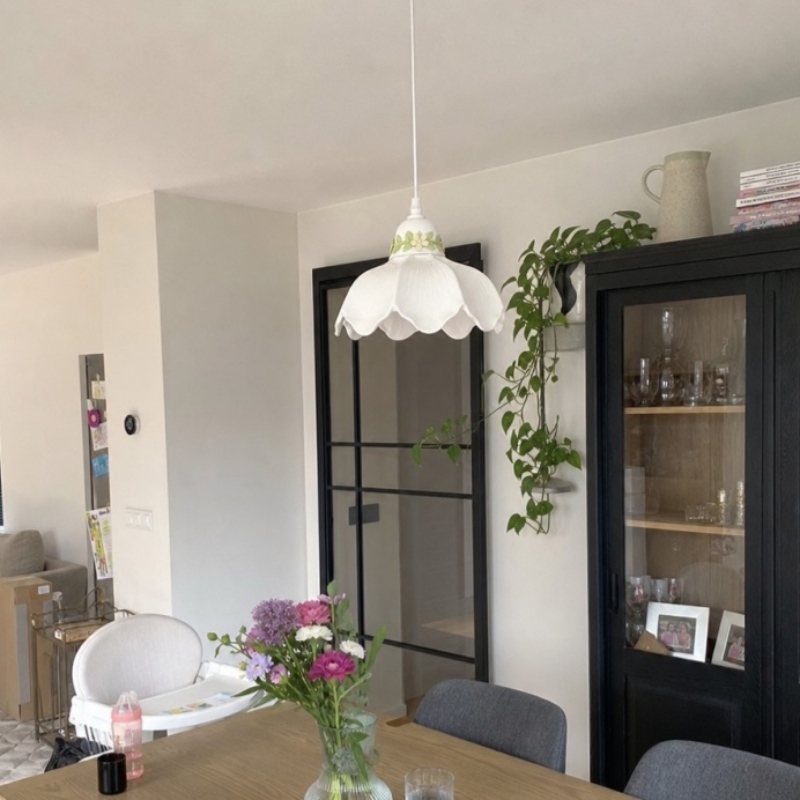 Customer room photo with the flower pendant lamp above a dining table